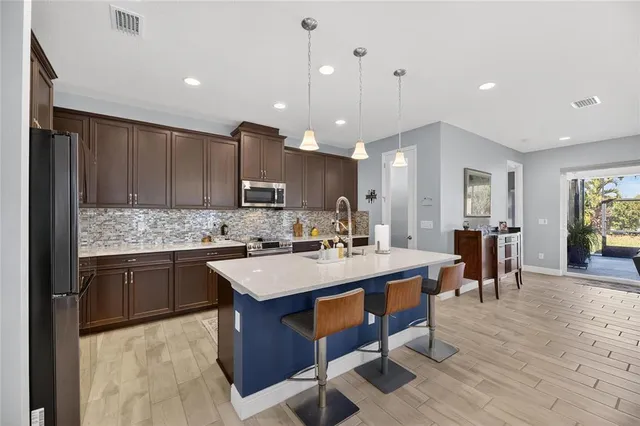 a large kitchen with a table and chairs