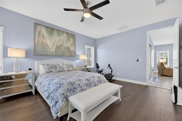 a bedroom with a bed and painting on the wall