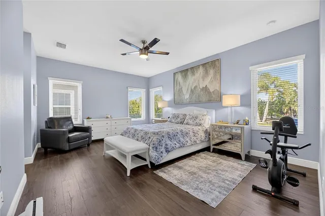 a bedroom with a bed a couch and a window