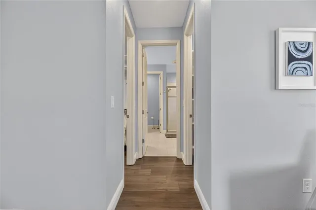 a view of a hallway with wooden floor