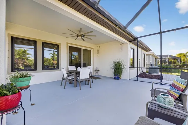 a dining room with furniture and a large window