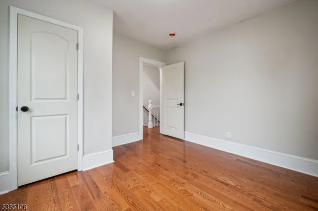 a view of an empty room and wooden floor