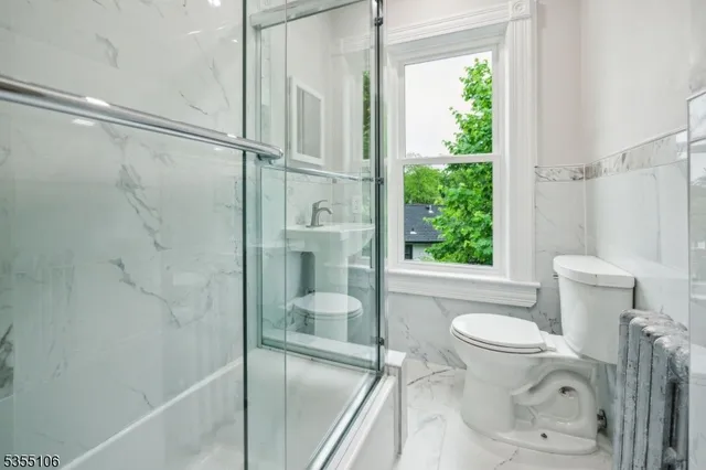 a bathroom with a toilet and a shower