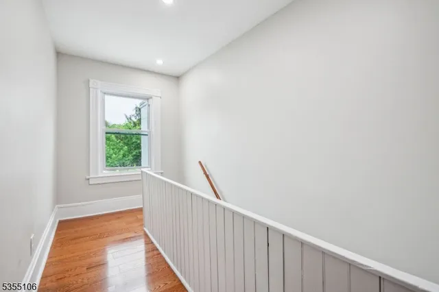 a view of hallway with wooden floor