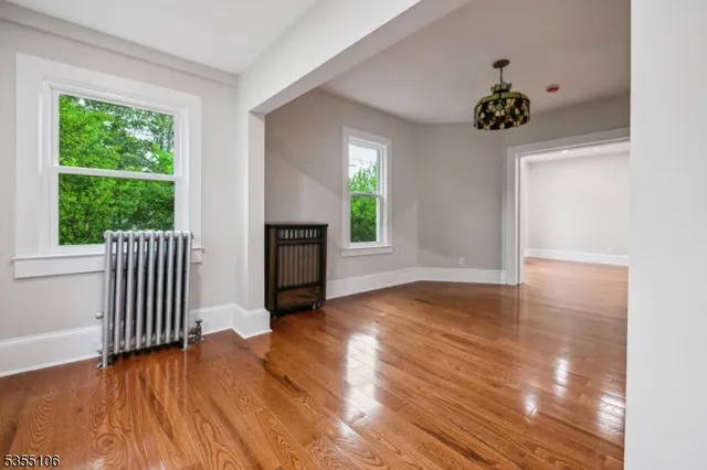 a view of a room with wooden floor and a window