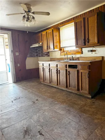 a view of kitchen with stainless steel appliances granite countertop a stove sink and cabinets