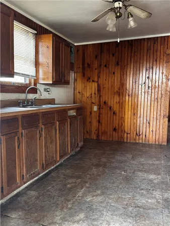 a kitchen with a sink cabinets and window