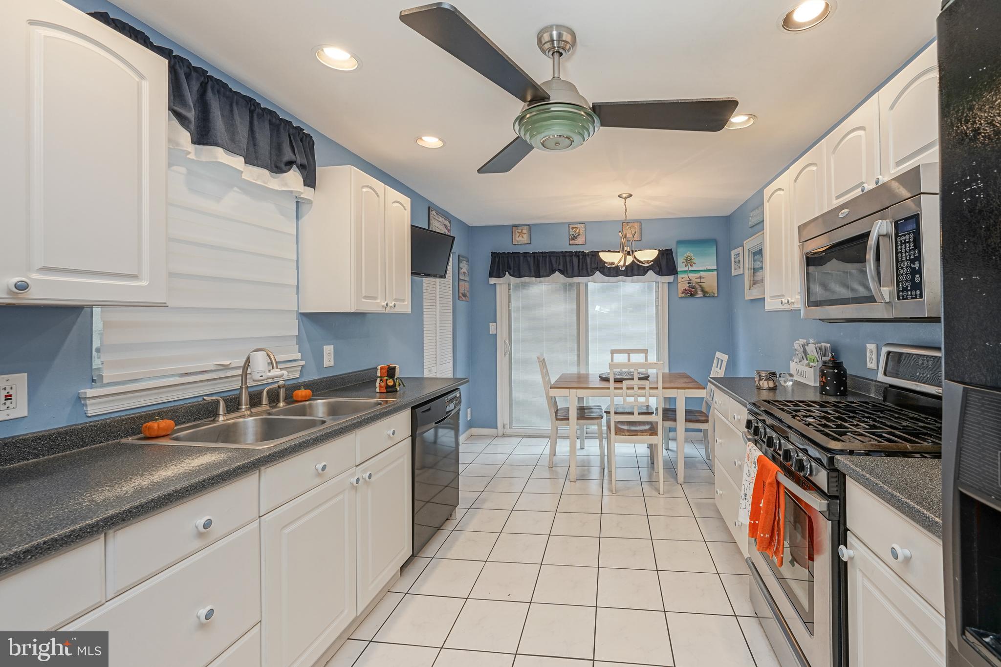 a kitchen with stainless steel appliances a sink a stove and cabinets