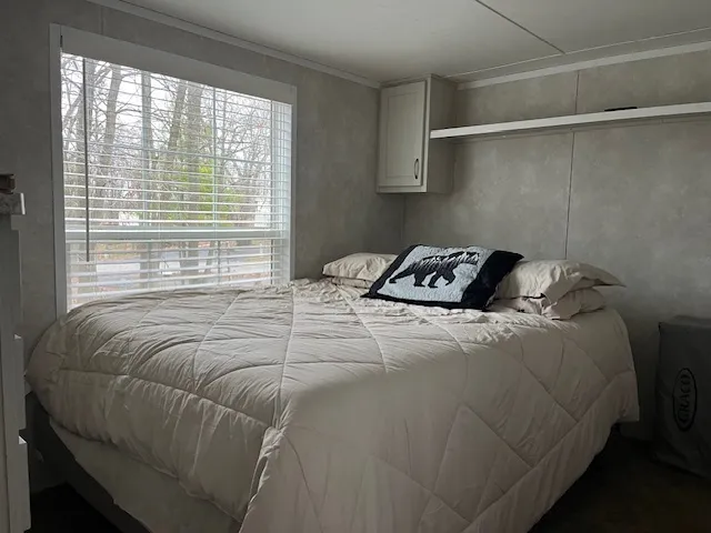 a bedroom with a bed and a flat screen tv