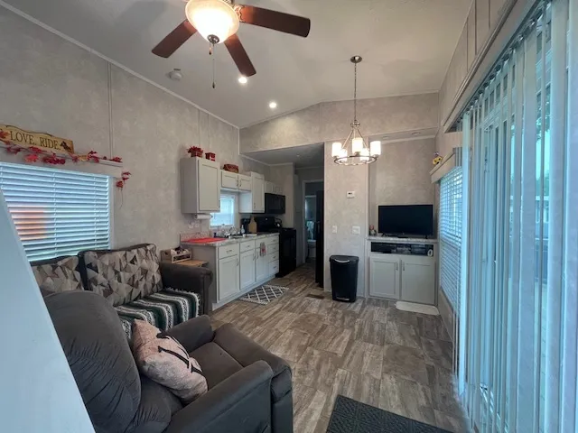 a living room with furniture fireplace and a window