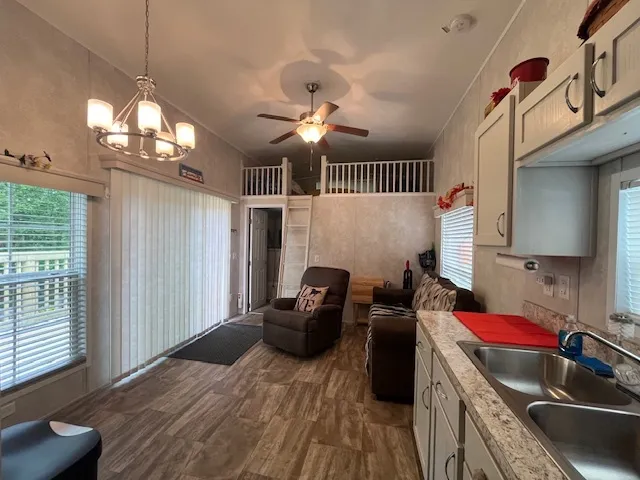 a kitchen with a refrigerator and a stove top oven