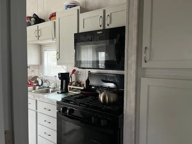 a kitchen with a refrigerator and a sink
