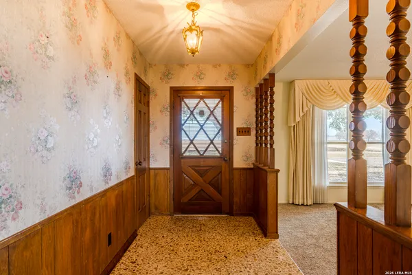 a view of entryway with a front door and wooden floor