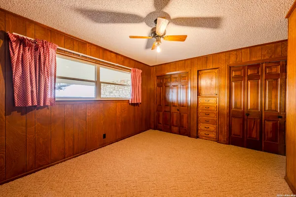 a view of a livingroom with a ceiling fan and window