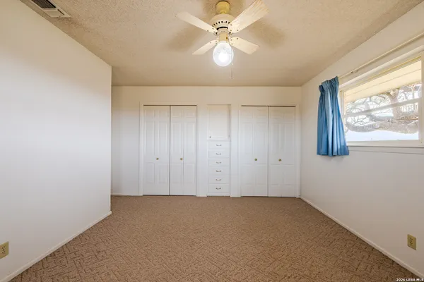 a view of a livingroom with an empty space and a window