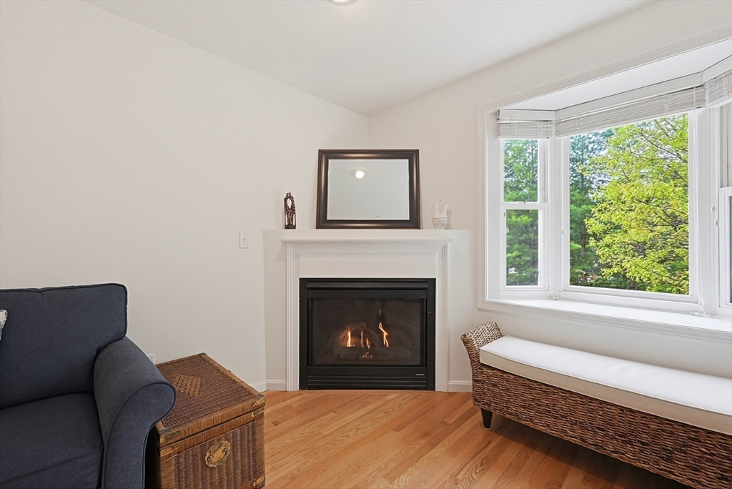 3002 Maple Brook Road, Unit 3002 Bellingham, MA 02019 - Photo 11 of 42 a living room with furniture and a fireplace