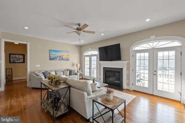 a kitchen with granite countertop a refrigerator cabinets and wooden floor
