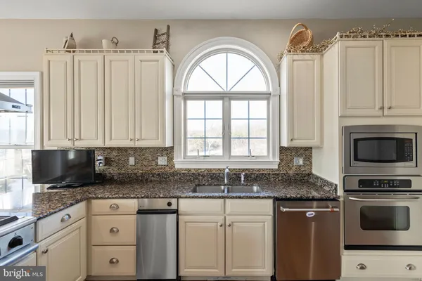 a large kitchen with a table and chairs