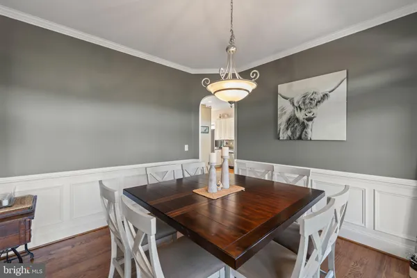 a bedroom with a bed and a dresser next to a window