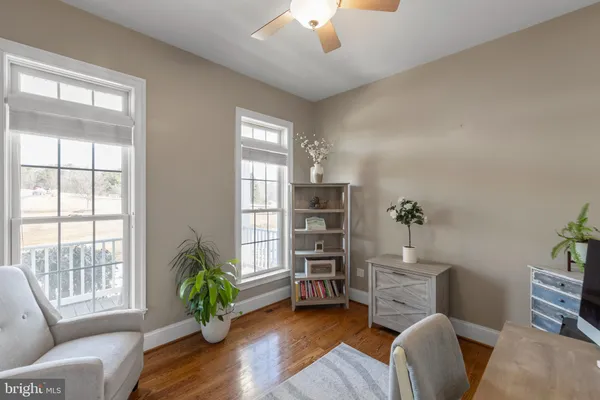 a spacious bedroom with a large bed and a flat tv screen on dresser