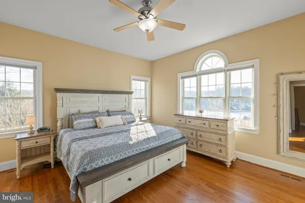 a spacious bedroom with a bed and a window
