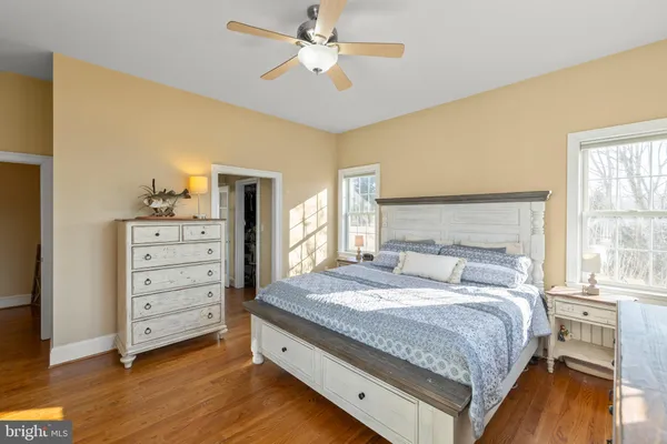 a living room with furniture and a large mirror