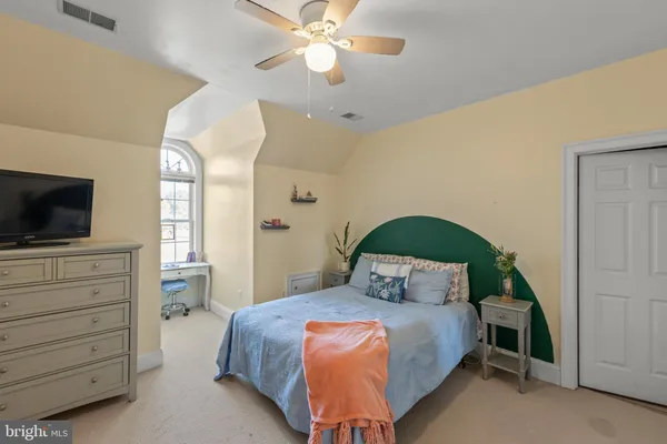 a view of a livingroom with workspace and a window