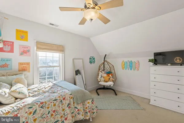 a view of a white house with a big yard and potted plants