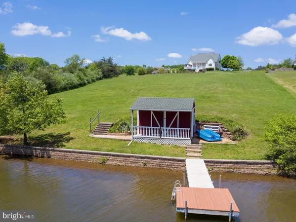 a living room with furniture floor to ceiling window and wooden floor