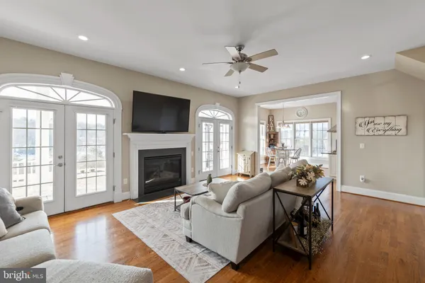 a kitchen with stainless steel appliances granite countertop a stove a sink a window and cabinets