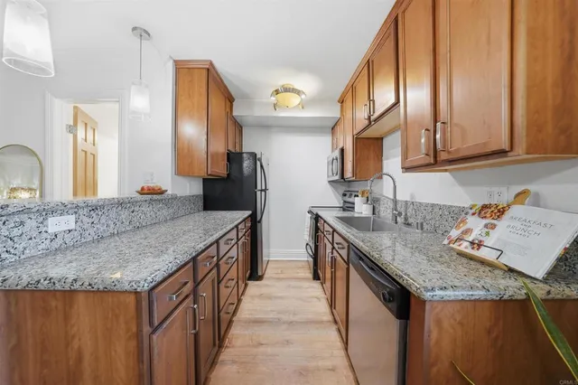 a kitchen with granite countertop a sink and a stove