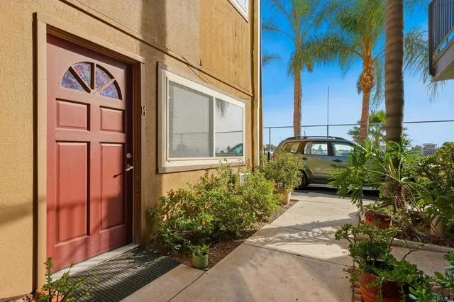 a couple of potted plants in front of door