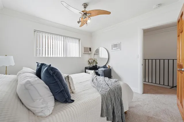 a bedroom with a bed and window