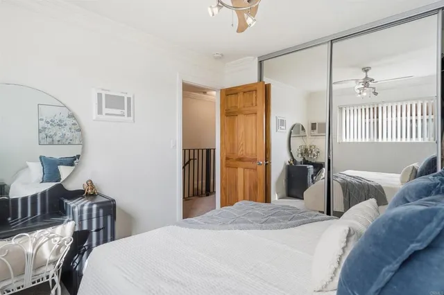 a bedroom with a large bed and a chandelier