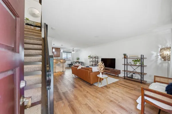 a living room with furniture and wooden floor
