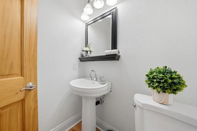 a bathroom with a sink a mirror and a toilet