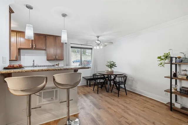 a dining room with furniture and wooden floor