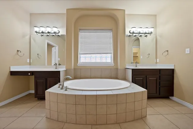 a bathroom with a sink tub and a mirror