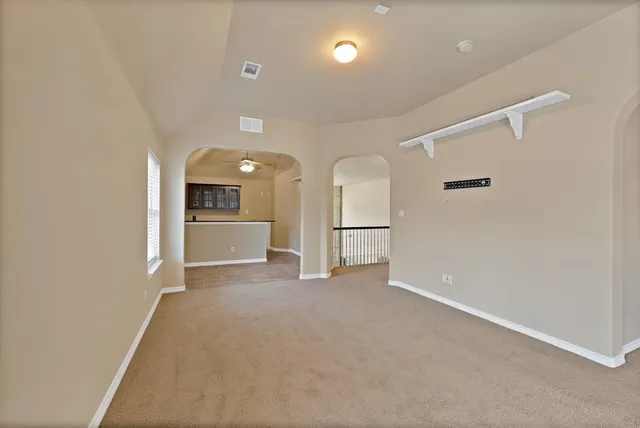 wooden floor in an empty room with a kitchen