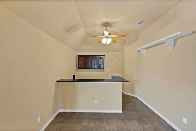 a view of a room with a sink and a mirror