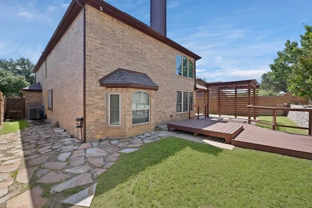 a view of an house with backyard and sitting area