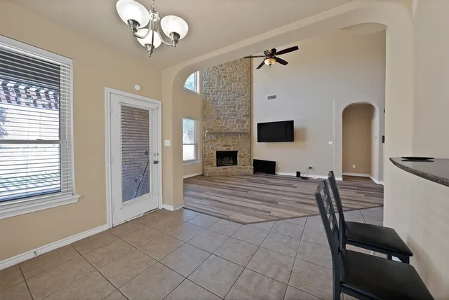 a spacious bedroom with a bed and a chandelier