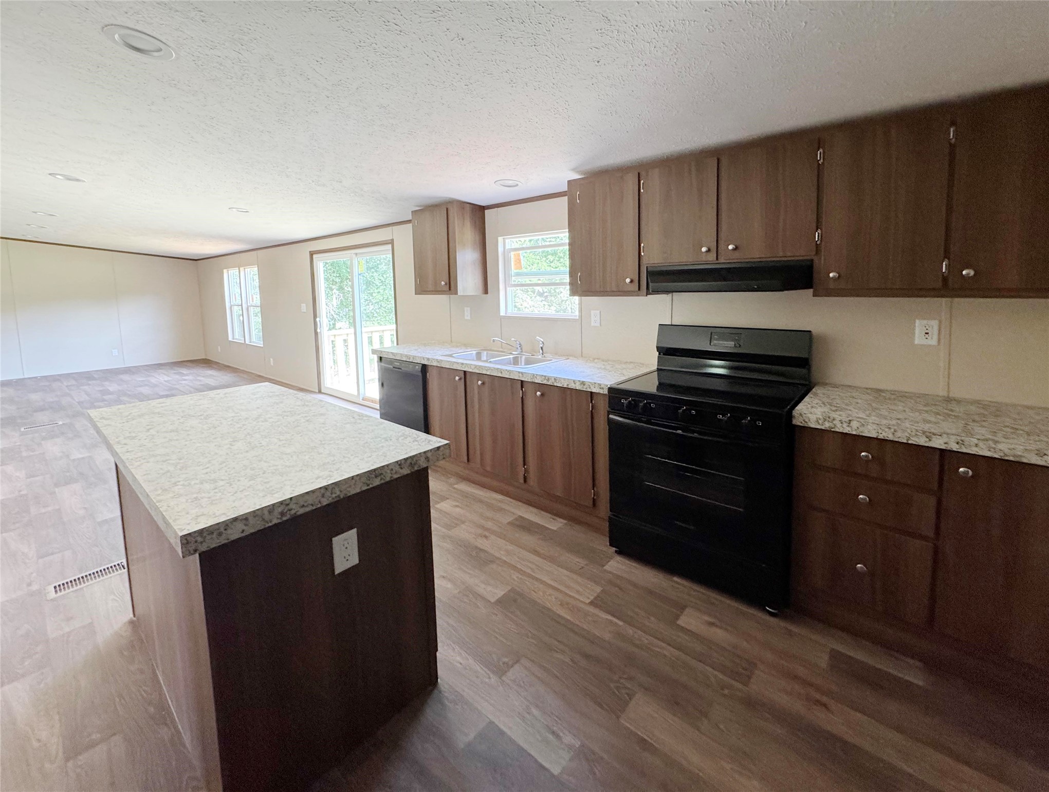 26817 Long Street Splendora, TX 77372 - Photo 11 of 18 a kitchen with granite countertop wooden cabinets and a granite counter tops