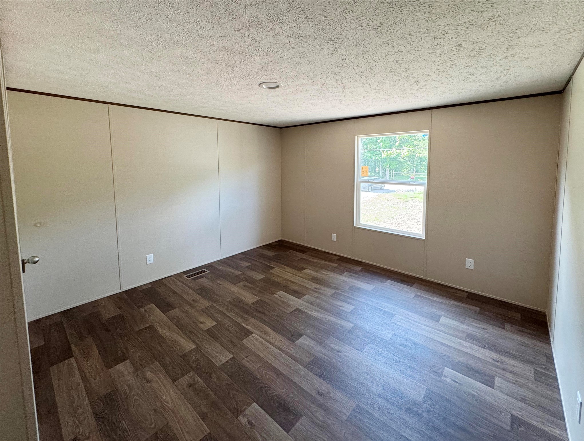 26817 Long Street Splendora, TX 77372 - Photo 14 of 18 an empty room with wooden floor and windows