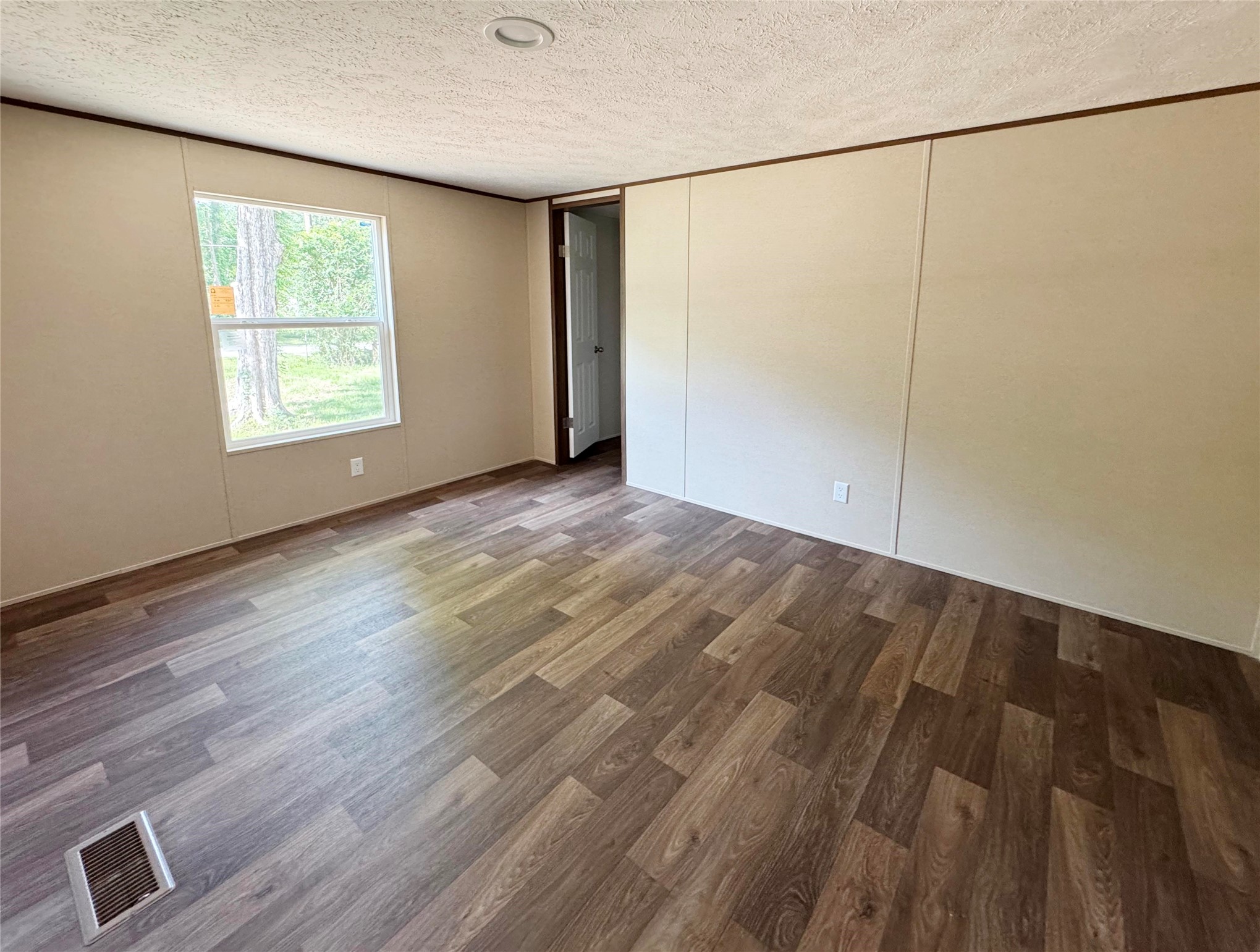26817 Long Street Splendora, TX 77372 - Photo 15 of 18 a view of an empty room with wooden floor and a window