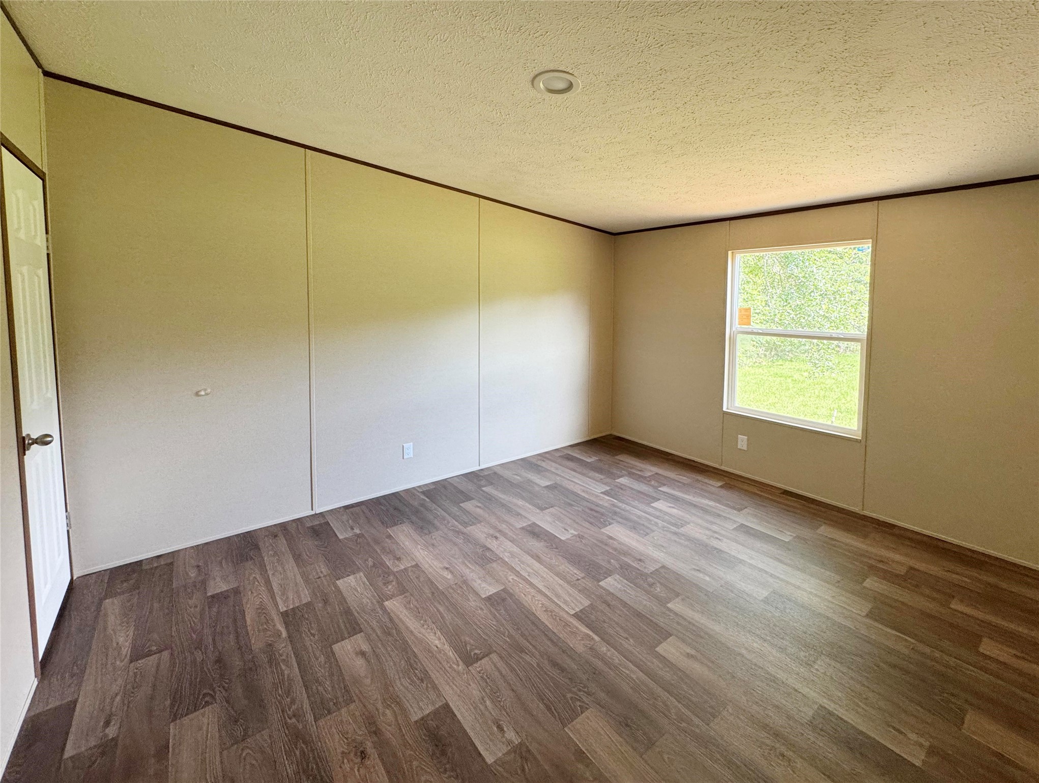 26817 Long Street Splendora, TX 77372 - Photo 16 of 18 an empty room with wooden floor and windows