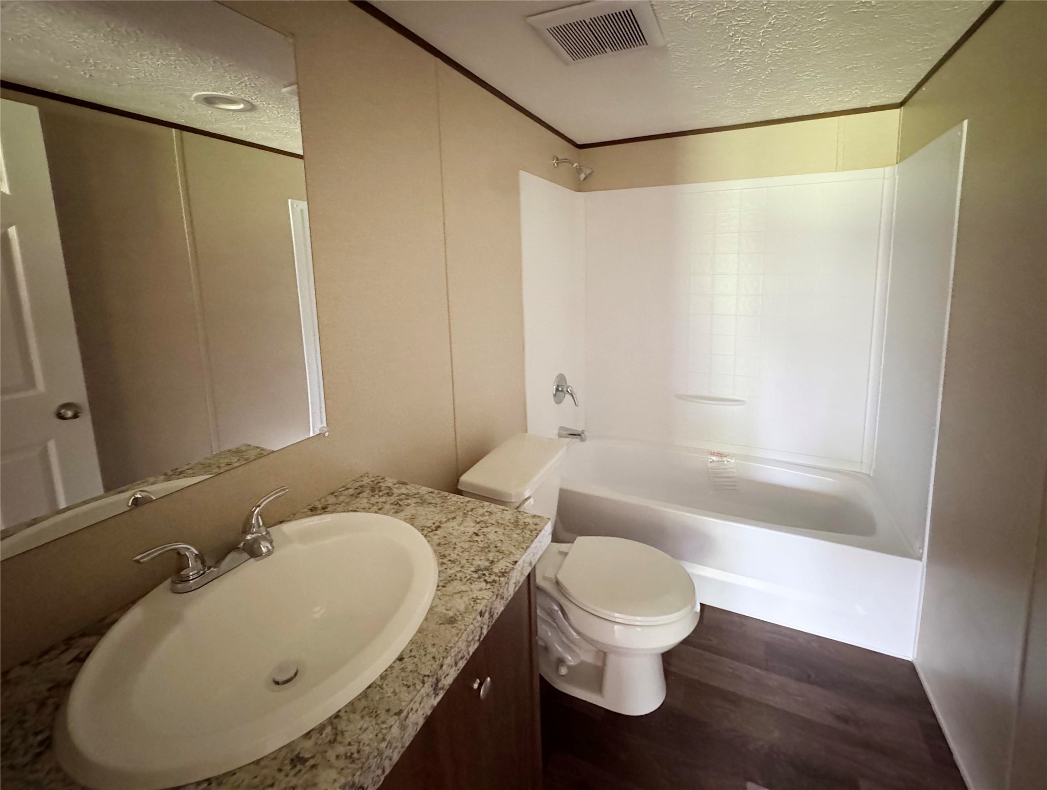 26817 Long Street Splendora, TX 77372 - Photo 17 of 18 a bathroom with a granite countertop sink toilet and shower