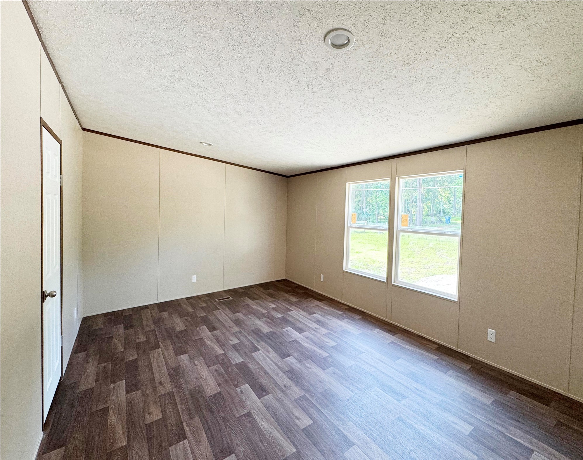 26817 Long Street Splendora, TX 77372 - Photo 5 of 18 an empty room with wooden floor and window
