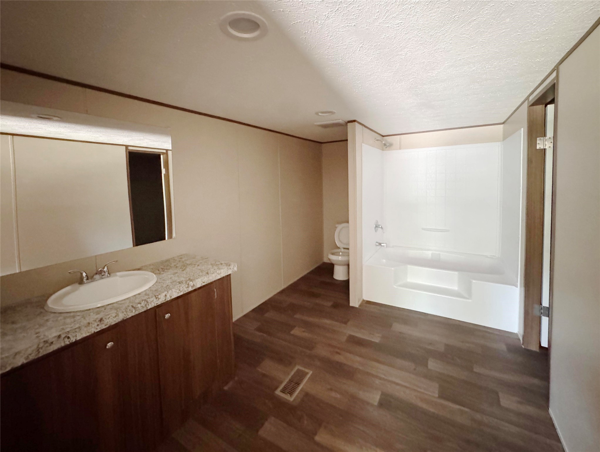 26817 Long Street Splendora, TX 77372 - Photo 6 of 18 a bathroom with a granite countertop sink and a mirror