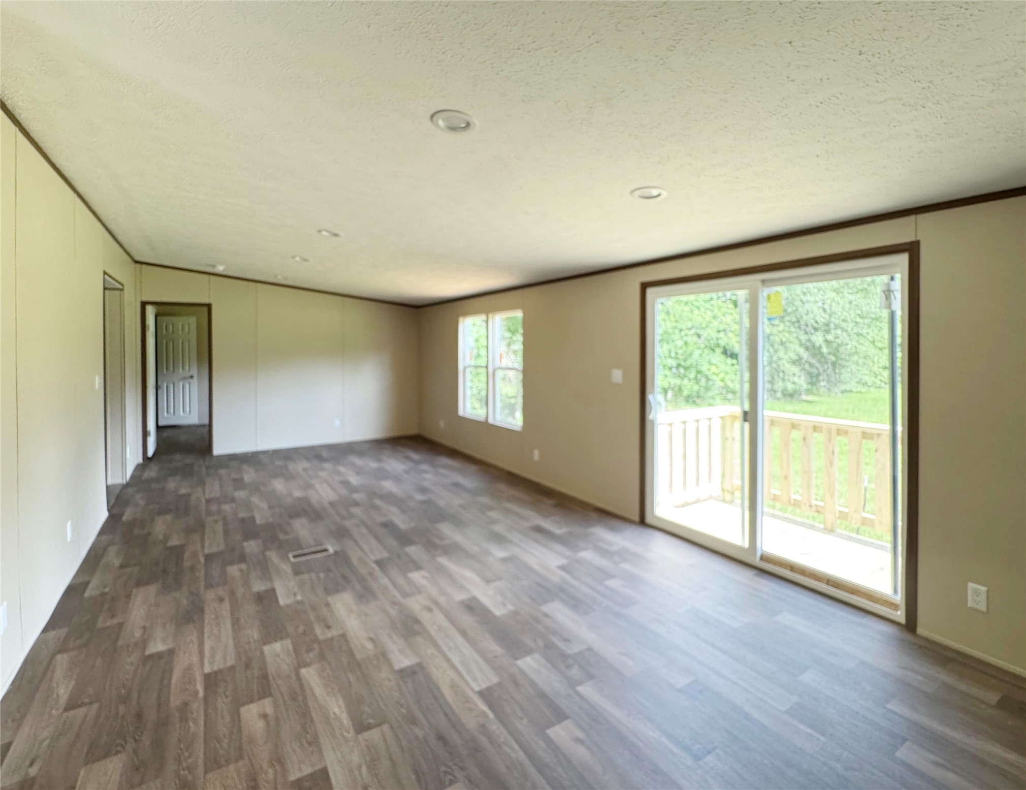 26817 Long Street Splendora, TX 77372 - Photo 7 of 18 a view of empty room with wooden floor and fan